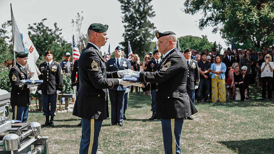 Veteran Flag folding at cemetery image